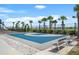 Community basketball court with benches, landscaping and a view of the pond and nearby homes at 582 8Th Nw St, Ruskin, FL 33570