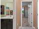 View from the hallway of bathroom vanity and mirror as well as the adjacent bedroom at 582 8Th Nw St, Ruskin, FL 33570