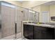 Modern bathroom with a double vanity, large mirror, and tiled shower, offering a luxurious experience at 582 8Th Nw St, Ruskin, FL 33570