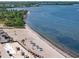 Aerial view of the beach with lounge chairs, landscaping and gulf views at 582 8Th Nw St, Ruskin, FL 33570