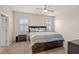 Cozy bedroom with a large bed featuring built-in storage and natural light from two windows at 582 8Th Nw St, Ruskin, FL 33570