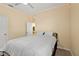 Bedroom showcasing a bed with white comforter and an open doorway to an ensuite bathroom at 582 8Th Nw St, Ruskin, FL 33570