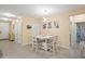 Cozy dining area featuring a white table set, modern lighting and access to the bathroom at 582 8Th Nw St, Ruskin, FL 33570