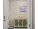 Inviting entryway featuring a decorative cabinet, artwork, and neutral wall colors at 582 8Th Nw St, Ruskin, FL 33570