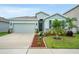 Charming single-Gathering home featuring a two-car garage and well-manicured landscaping at 582 8Th Nw St, Ruskin, FL 33570