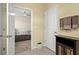 Hallway view into bedroom and bathroom, with neutral paint and tile floor at 582 8Th Nw St, Ruskin, FL 33570
