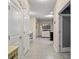 Bright hallway leading to the living area, with multiple doorways and neutral tones at 582 8Th Nw St, Ruskin, FL 33570