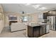 Open kitchen featuring a granite island, stainless steel appliances, and views into the living space at 582 8Th Nw St, Ruskin, FL 33570