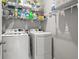 Well-organized laundry room with a washer, dryer, and ample shelving for storage at 582 8Th Nw St, Ruskin, FL 33570