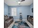 Comfortable media room with a plush sofa, large window, and home theater setup at 582 8Th Nw St, Ruskin, FL 33570