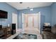 Spacious living room with tile floors, blue walls, media center, and view of multiple rooms at 582 8Th Nw St, Ruskin, FL 33570