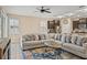 Open-concept living room with a large sectional couch and view into the kitchen area at 582 8Th Nw St, Ruskin, FL 33570