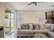 Bright living room with sliding glass door, plush sofa, and view of the backyard at 582 8Th Nw St, Ruskin, FL 33570