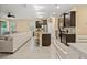 Open-concept living space with a modern kitchen, island seating, and a comfortable living room setup at 582 8Th Nw St, Ruskin, FL 33570