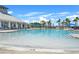 A refreshing pool with clear blue water, surrounded by palm trees and comfortable lounge chairs at 582 8Th Nw St, Ruskin, FL 33570