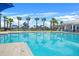 Resort-style pool with palm trees, playground, and ample seating for a relaxing and fun experience at 582 8Th Nw St, Ruskin, FL 33570
