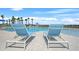 Relaxing poolside view with comfortable lounge chairs and palm trees creating a vacation-like atmosphere at 582 8Th Nw St, Ruskin, FL 33570