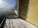 View from the balcony with gray railings, brick chimney, and yellow siding at 625 25Th S Ave, St Petersburg, FL 33705