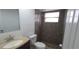 Bathroom featuring a granite countertop, modern sink, vanity, mirror, and tile shower at 7024 Coral Reef Dr, Port Richey, FL 34668