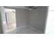 Cozy bedroom features ceiling fan and tile flooring at 7024 Coral Reef Dr, Port Richey, FL 34668