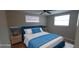 Cozy bedroom featuring modern furniture, wood flooring, two windows, and a ceiling fan at 7024 Coral Reef Dr, Port Richey, FL 34668