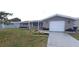 Charming single-story home with a well-manicured front yard and an attached garage at 7024 Coral Reef Dr, Port Richey, FL 34668