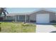 Charming single Gathering home features well-maintained front yard and attached one car garage at 7024 Coral Reef Dr, Port Richey, FL 34668