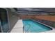 Refreshing pool with stone accents, under a screened enclosure, provides a private outdoor oasis for relaxation and enjoyment at 7024 Coral Reef Dr, Port Richey, FL 34668
