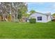 The back yard boasts a spacious, well-manicured lawn and mature landscaping for privacy at 7107 Pond View Ct, Spring Hill, FL 34606