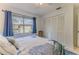 Bright bedroom featuring ample closet space, and natural light from the large windows at 7107 Pond View Ct, Spring Hill, FL 34606