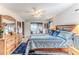 Well-lit bedroom with a comfy bed, dresser, mirror, and access to the outdoor patio at 7107 Pond View Ct, Spring Hill, FL 34606