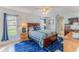 Cozy bedroom with comfortable bed, side tables with lamps, and bright blue rug at 7107 Pond View Ct, Spring Hill, FL 34606