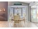 Cozy dining area with bay window and shutters, creating a bright and inviting space at 7107 Pond View Ct, Spring Hill, FL 34606