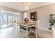 Bright dining room featuring a modern table, stylish light fixture, and sliding doors to a sunroom at 7107 Pond View Ct, Spring Hill, FL 34606