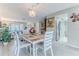 Open-concept dining area with light wood floors, modern table, and seamless flow to the living spaces at 7107 Pond View Ct, Spring Hill, FL 34606