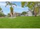 Beautiful single-story home boasting lush landscaping, bright blue trim, and a well-maintained lawn at 7107 Pond View Ct, Spring Hill, FL 34606