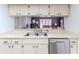 Updated kitchen with stainless steel dishwasher, sink, and ample cabinet space; an easy flow to living area at 7107 Pond View Ct, Spring Hill, FL 34606