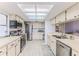 Well-lit kitchen with stainless steel appliances, white cabinetry, and a bright, airy ambiance at 7107 Pond View Ct, Spring Hill, FL 34606