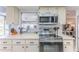 Modern kitchen featuring stainless steel appliances, white countertops, and ample cabinet space at 7107 Pond View Ct, Spring Hill, FL 34606