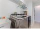 Functional laundry room with modern washer and dryer, utility sink, and convenient storage solutions at 7107 Pond View Ct, Spring Hill, FL 34606