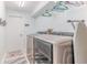 Clean laundry room with modern washer and dryer units, ample space, and a tidy appearance at 7107 Pond View Ct, Spring Hill, FL 34606