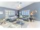 Bright and airy living room with stylish furnishings, ceiling fan, and neutral color palette at 7107 Pond View Ct, Spring Hill, FL 34606