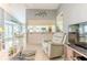Open-concept living area with views to the dining room and kitchen, filled with natural light at 7107 Pond View Ct, Spring Hill, FL 34606