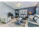 Inviting living room featuring contemporary decor, comfortable seating, and ample natural light at 7107 Pond View Ct, Spring Hill, FL 34606