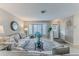 Bright living room with neutral decor, large bay windows, and comfortable seating at 7107 Pond View Ct, Spring Hill, FL 34606