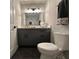 Bathroom with vanity, toilet, and a decorative mirror at 7336 Ivory Ter, New Port Richey, FL 34655