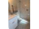 Stylish bathroom featuring patterned tile flooring, a walk-in shower, and elegant fixtures at 7336 Ivory Ter, New Port Richey, FL 34655