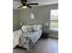 Cozy bedroom with plush bedding, neutral walls, and a large window at 7336 Ivory Ter, New Port Richey, FL 34655