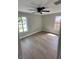 This cozy bedroom has beautiful floors, a fan, and plenty of natural light from the windows at 7336 Ivory Ter, New Port Richey, FL 34655