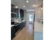 Modern kitchen with stainless steel appliances, hardwood floors, and updated lighting at 7336 Ivory Ter, New Port Richey, FL 34655